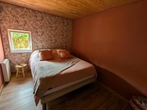 a small bedroom with a bed and a window at Gite Chez Tof et Ninie in Houlle +12 photos