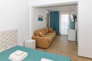 a living room with a couch and a table at Angelina Hotel in Ormos Panagias