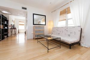a living room with a couch and a glass table at Best Location In South Beach Steps To Everything! in Miami Beach