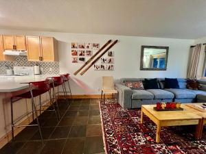 a living room and kitchen with a couch and a table at Panorama Mountain Resort - Horsethief Lodge with Fairmont Creek in Panorama