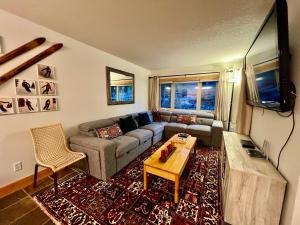 a living room with a couch and a table at Panorama Mountain Resort - Horsethief Lodge with Fairmont Creek in Panorama
