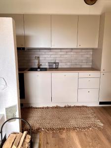 a kitchen with white cabinets and a sink at Rinneköngäs - Ruka-Pyhä 2x SKIPASS included in Ruka