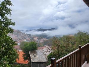 a view of a city in the clouds at MELATO HOUSES in Valtessiniko