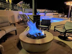 a fire pit in a patio with chairs and a pool at 30-31| 2 Homes in St George with Private Pools and Hot Tubs in Santa Clara