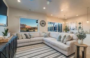a living room with a large couch and a clock at 29-30 | 2 Connected Homes in Ocotillo Springs with Pool and Spas in Santa Clara