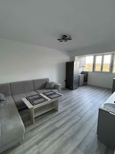 a living room with a couch and a table at Апартамент in Dupnitsa
