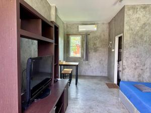 a living room with a flat screen tv and a bedroom at The Poom Garden Khao Yai in Ban Khanong Phra Klang (1)