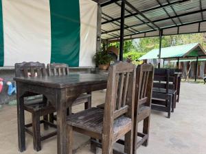 a wooden table with four chairs and a tent at The Poom Garden Khao Yai in Ban Khanong Phra Klang (1)