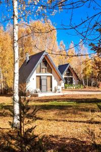 a small white house in the middle of a field at Wild Beauty Brezna in Pluzine
