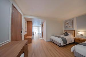 a large hotel room with a bed and a hallway at Maison Lake View Luang Prabang in Luang Prabang