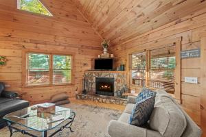 a living room with a fireplace in a log cabin at Timber Lodge in Todd