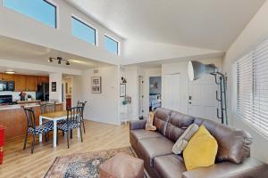 a living room with a couch and a dining room at Mtn-View Condo w/ Resort Amenities in Tucson! in Tucson