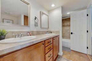 a bathroom with a sink and a mirror and a tub at Mtn-View Condo w/ Resort Amenities in Tucson! in Tucson +13 photos