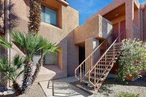 a house with a staircase in front of it at Mtn-View Condo w/ Resort Amenities in Tucson! in Tucson