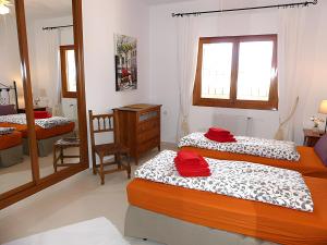 a bedroom with two beds and a dresser in it at Casa Romero in Caleta De Velez +26 photos