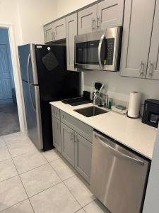 a kitchen with a stainless steel refrigerator and a sink at Cozy apartment near legoland in Eagle Lake