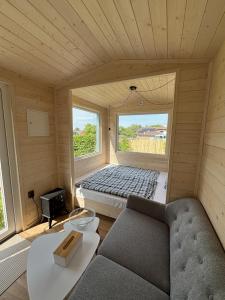 a small room with a couch and a window at Celoročně obyvatelná maringotka Kratochvíle  +4 photos