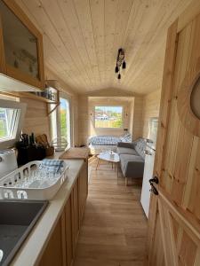 a kitchen and living room of a tiny house at Celoročně obyvatelná maringotka Kratochvíle 