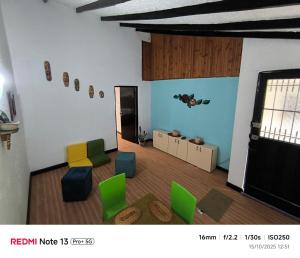 a living room with green and yellow chairs at Nina House, Cali, Valle del Cauca in Cali