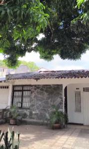 a house with a gate and a stone wall at Nina House, Cali, Valle del Cauca in Cali
