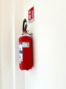 a red fire hydrant hanging on a wall at A DUE PASSI da BARI - La Casa della Nonna al 39 in Noicattaro
