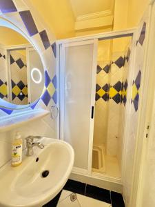 a bathroom with a sink and a shower at A12 Studio cosy Tamraght Idéal nomades & surfers in Tamraght Ouzdar