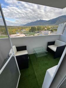 a balcony with a table and chairs and a view at Апартамент in Dupnitsa