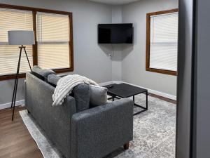 a living room with a couch and a table at DTW Suites in Romulus