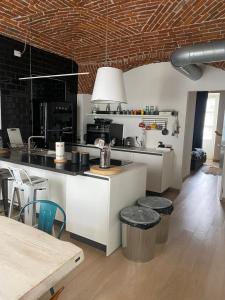 a kitchen with a counter and a table with chairs at CASA JACK Open Space Piazza Galimberti in Cuneo +10 photos