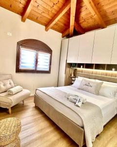 a bedroom with a large bed and a window at AnnOra in SantʼAntìoco