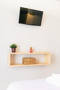 a shelf with a tv on a white wall at La Palomilla in Avila