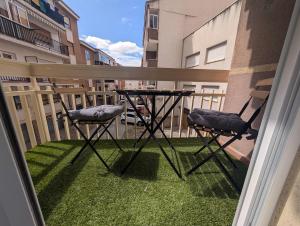 a balcony with two chairs and a table on the grass at La Palomilla in Avila +52 photos