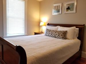 a bedroom with a large bed with a pillow on it at Bright Front Facing Unit - Private Front Farmers Porch in Manchester +21 photos