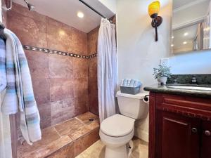 a bathroom with a toilet and a shower at Destination #36 in Anaheim +16 photos