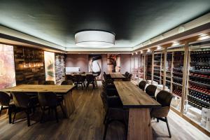 a wine tasting room with wooden tables and chairs at Hotel Schmachtendorf in Oberhausen