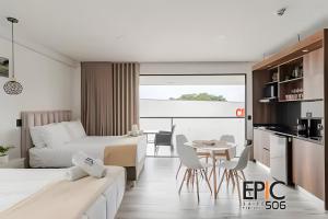 a hotel room with two beds and a table at Epic Suite 506 Deluxe Aeropuerto in Cuba