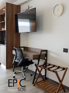 an office with a desk and a chair and a tv at Epic Suite 506 Deluxe Aeropuerto in Cuba +20 photos