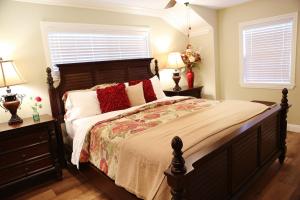 a bedroom with a large bed with red pillows at Destination #26 in Anaheim