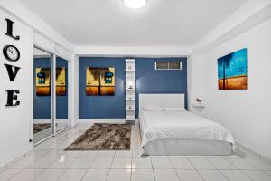 a bedroom with blue walls and a white bed at Balcony Pet-friendly Parking Leisure in Beltran