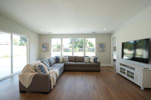 a living room with a couch and a flat screen tv at Destination #45 in Orange