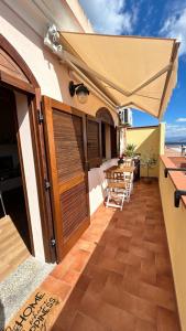 a patio with an umbrella and a table at AnnOra in SantʼAntìoco +1 photo