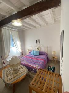 a bedroom with a bed and a table and a window at La Casa di Antonella in Frascati
