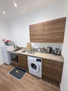 una cocina con estufa y lavadora en Apartment 3- 216 high Street, en Arbroath