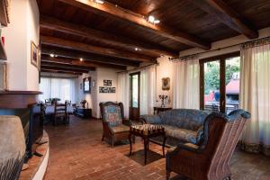 a living room with a couch and chairs and a table at Villa Adele - Historic Dimora with pool & sea view in Senigallia