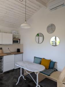 a living room with a table and a kitchen at Esprit Cabane au Cœur du Teich in Le Teich