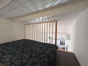 a bedroom with a large bed in a room at Esprit Cabane au Cœur du Teich in Le Teich +13 photos