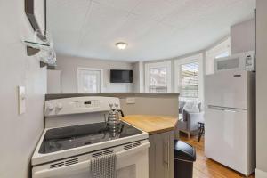 Una cocina con estufa y refrigerador blanco. en Sleek & Bright 1st Flr Studio Short -Midterm Stays, en Manchester