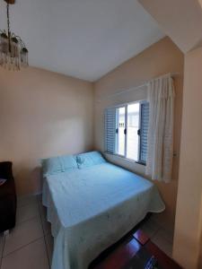 Ένα ή περισσότερα κρεβάτια σε δωμάτιο στο Estúdio acolhedor e versátil