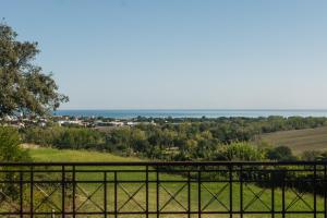 a view of the ocean from a fence at Villa Adele - Historic Dimora with pool & sea view in Senigallia