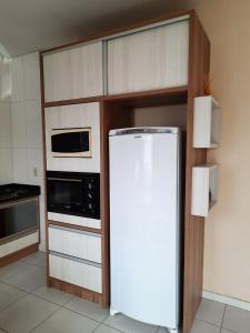 Η κουζίνα ή μικρή κουζίνα στο Estúdio acolhedor e versátil